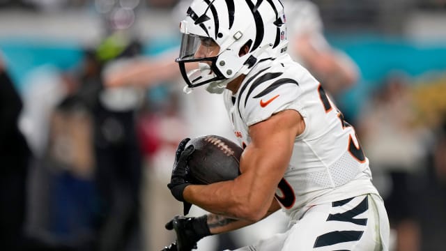 Cincinnati Bengals running back Chase Brown (30) takes a carry from Cincinnati Bengals quarterback Jake Browning (6) in the first half of a Week 13 NFL football game against the Jacksonville Jaguars, Monday, Dec. 4, 2023, at EverBank Stadium in Jacksonville, Fla.